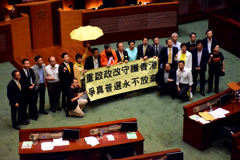 Pan-democracy legislators showing a banner