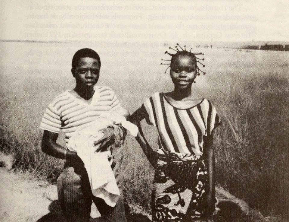 Parents with a newborn on the way to have the baby baptized, Bandundu Region