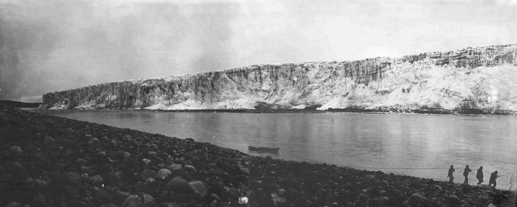 Panoramic view of Childs Glacier with group of men pulling a rowboat, 1906 (HEGG 790)