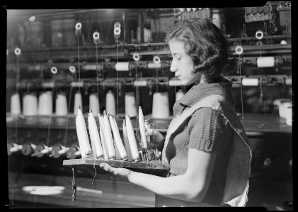 Paterson, New Jersey - Textiles. Quiller with rack of full quills which are ready to be inserted in shuttles for... - NARA - 518572