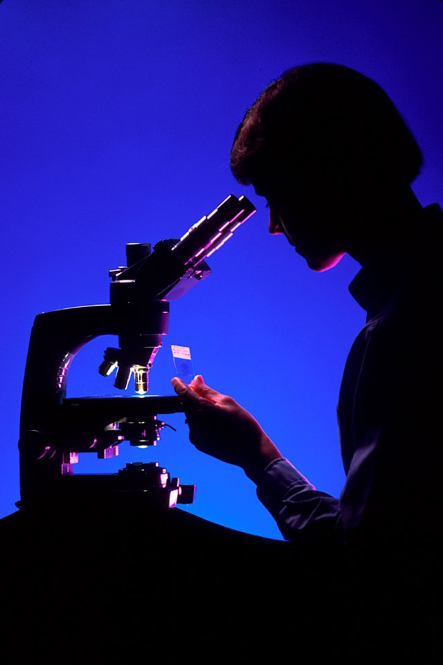 Pathologist with microscope