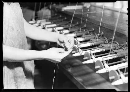 Paterson, New Jersey - Textiles. Quiller tying the broken ends of thread being wound on to quills. - NARA - 518561