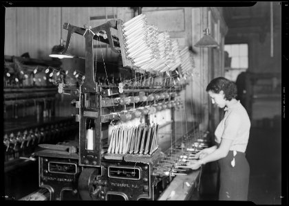 Paterson, New Jersey - Textiles. Quilling. The thread is wound from the cones, seen in an upright position on the... - NARA - 518544