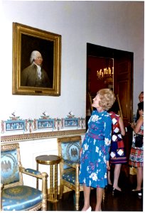 Pat Nixon Standing by a Portrait of John Adams