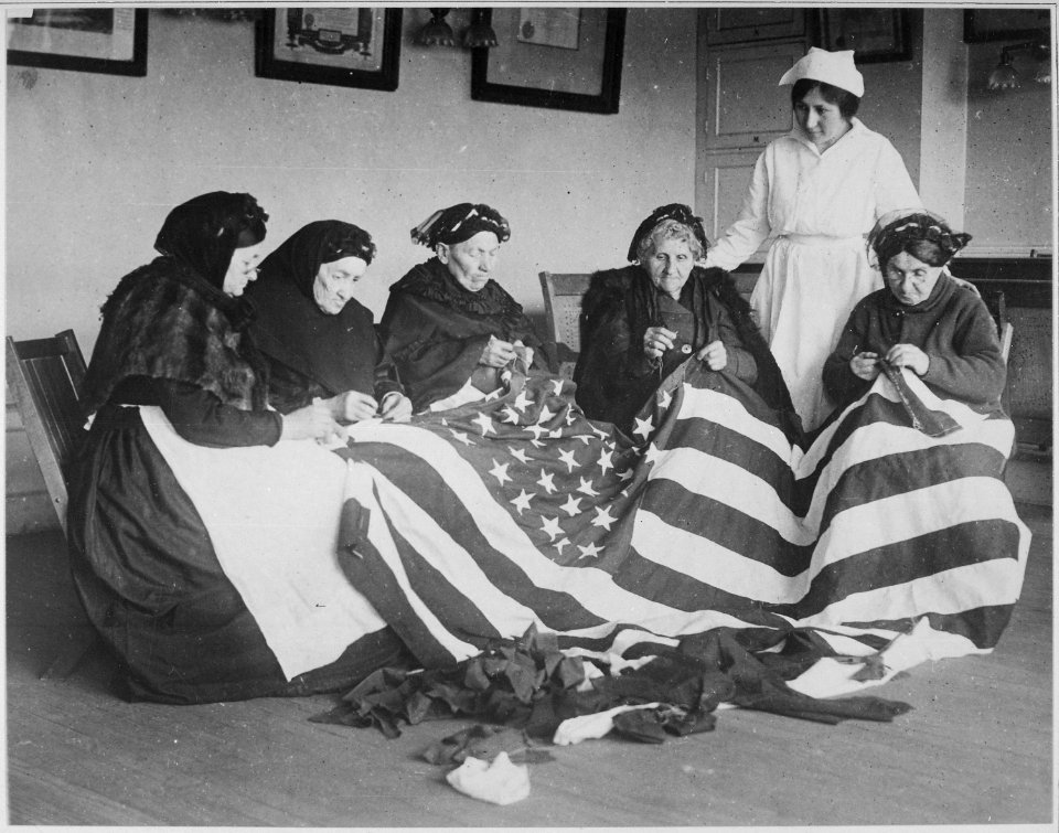 Patriotic old women make flags. Born in Hungary, Galicia, Russia, Germany, Rumania. Their flag-making instructor, Rose R - NARA - 533657
