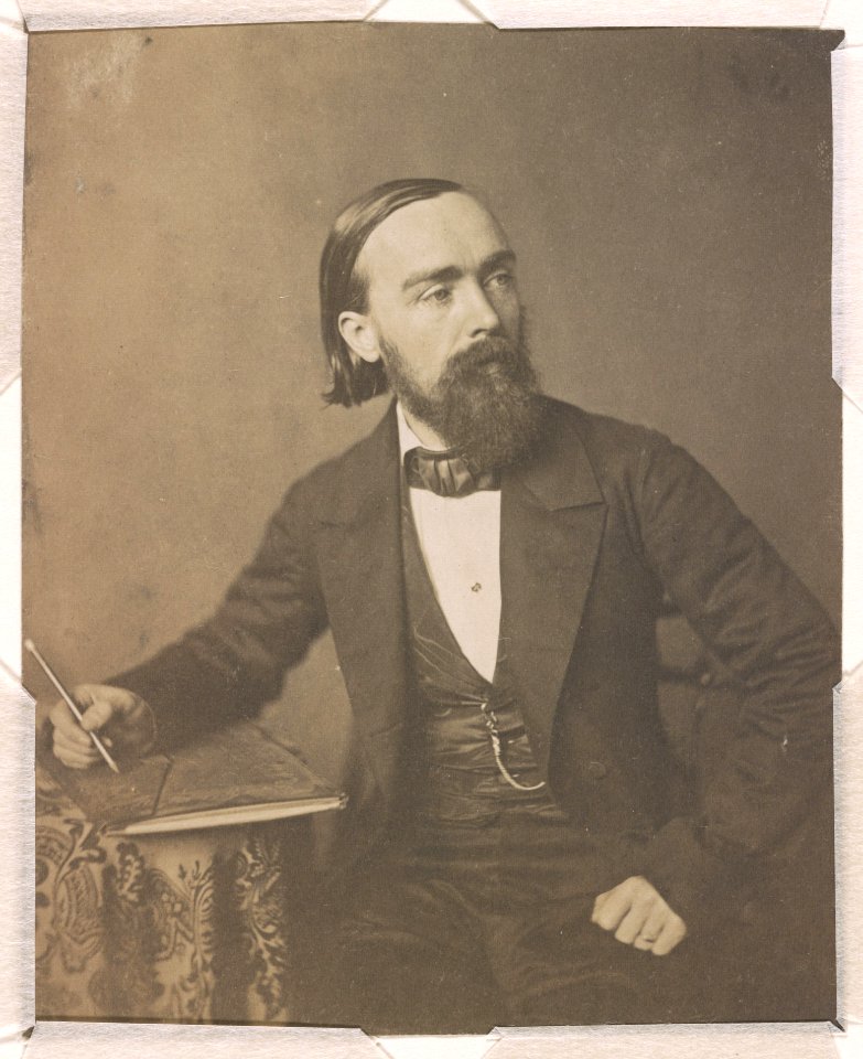 Paul Weber, artist, three-quarter length studio portrait, seated, holding pencil in right hand on sheaf of paper on a table, facing right LCCN2015651551