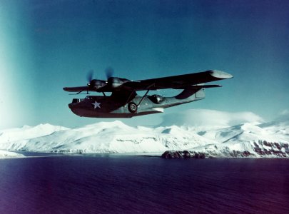 PBY-5A Catalina flies on patrol near a snowy Aleutian Island c1943