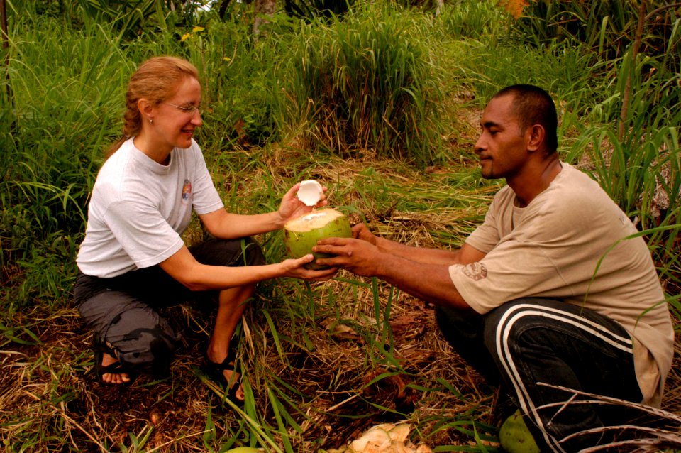 Peace Corps Volunteer prepares a coconut