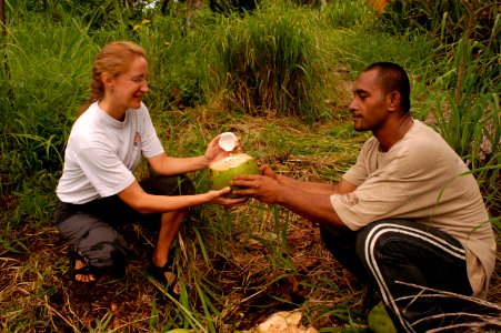 Peace Corps Volunteer prepares a coconut photo