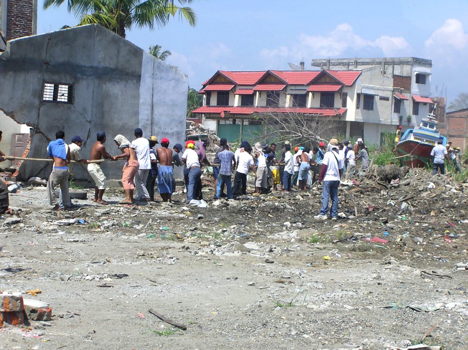 People cleaning up after 2004 earthquake and tsunami disaster; USAID Indonesia; January 2005