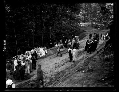 People in costumes in forest and group with motion picture camera LCCN2016891396