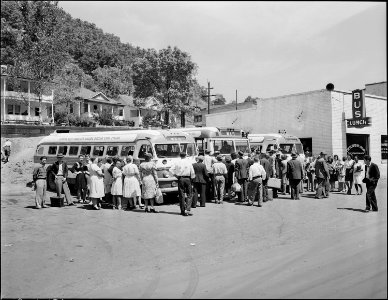 People boarding the bus, an important mode of transportation between the many nearby coal camps and towns. War... - NARA - 541015