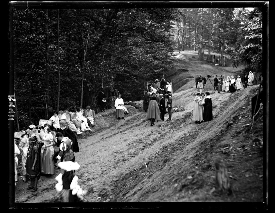 People in costumes in forest and group with motion picture camera LCCN2016891397