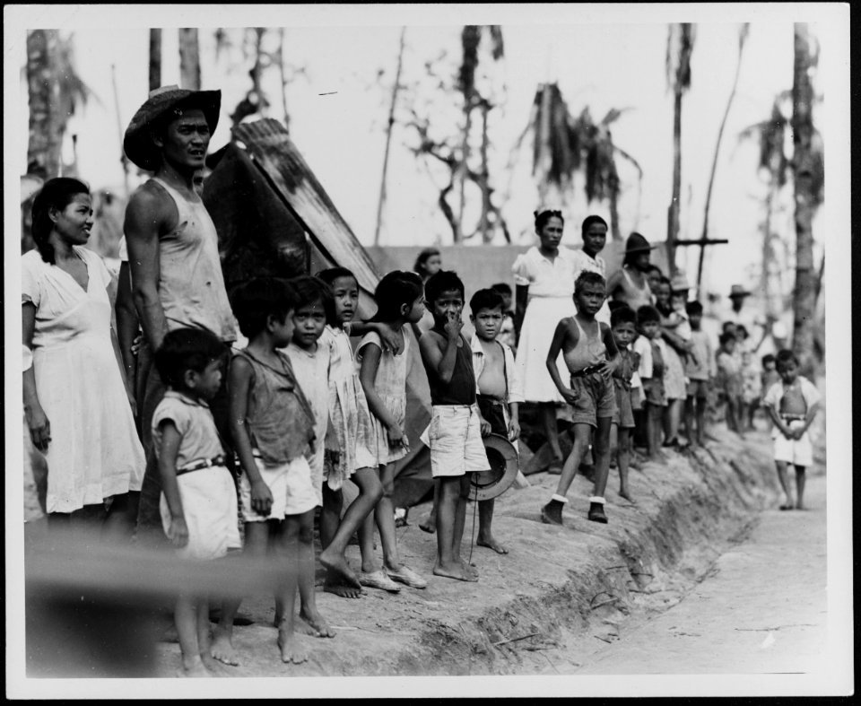 People of Hagåtña greet Admirals Nimitz and Spruance on 12 August 1944