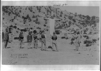 Penitents crucifying one of their own- person on huge wooden cross, which is held up by ropes; men watching LCCN2006684444