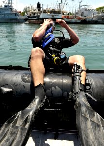 US Navy 110727-N-KB666-138 Master Seaman John Penney enters the water to conduct search operations with Mobile Diving and Salvage Unit (MDSU) 2 photo