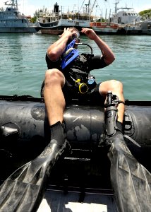 US Navy 110727-N-KB666-138 Master Seaman John Penney enters the water to conduct search operations with Mobile Diving and Salvage Unit (MDSU) 2