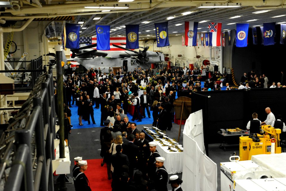 Peruvian service members and officials join U.S. Sailors and Marines on the amphibious assault ship USS America (LHA 6) for a reception in Callao, Peru, Sept 140901-N-LQ799-025