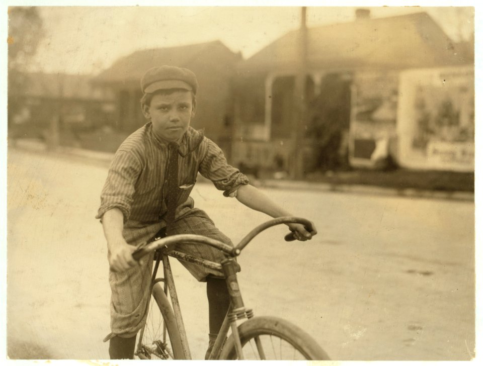 Percy Neville in the heart of the Red Light district. Just come out of one of the houses with message (which see in his hand). He said gleefully 'She gimme a quarter tip.' See also Hine LOC cph.3b47848