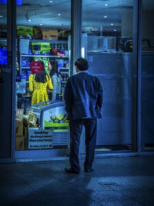 Man outside grocery photo