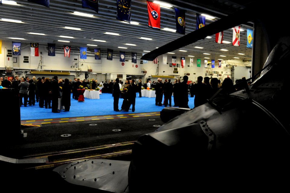 Peruvian service members and guests join U.S. Sailors and Marines on the amphibious assault ship USS America (LHA 6) for a reception in Callao, Peru, Sept 140901-N-LQ799-249