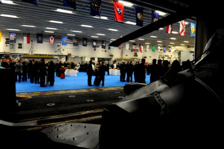 Peruvian service members and guests join U.S. Sailors and Marines on the amphibious assault ship USS America (LHA 6) for a reception in Callao, Peru, Sept 140901-N-LQ799-249