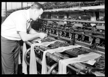 Philadelphia, Pennsylvania - Hosiery. Minnesac Mills. (Man working at machine with draped stockings.) - NARA - 518692