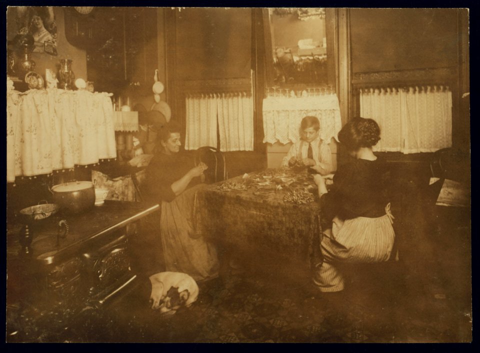 Photo taken after 9 P.M. Mrs. Barattini, Janitress at 212 Sullivan St., N.Y., and son Louis, 14 years old, and daughter who works in a flower factory all day and helps her mother make these LOC nclc.04140