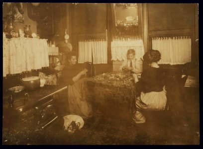 Photo taken after 9 P.M. Mrs. Barattini, Janitress at 212 Sullivan St., N.Y., and son Louis, 14 years old, and daughter who works in a flower factory all day and helps her mother make these LOC nclc.04140