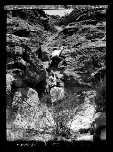 Petra. Umm el-Biyarah. (Earliest Nabatean stronghold). Final ascent showing climber scaling a difficult pass LOC matpc.16295