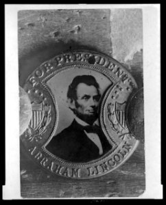 Photograph of a campaign button with portrait of Abraham Lincoln and inscription For President Abraham Lincoln LCCN2004678569