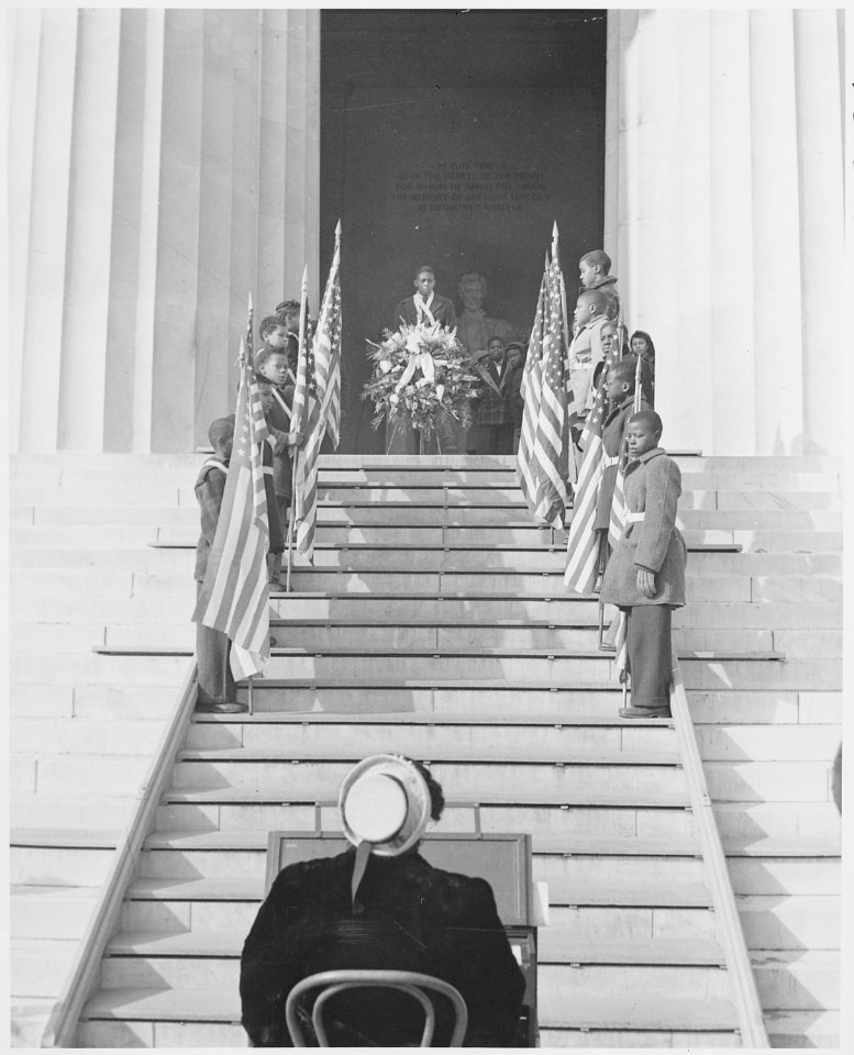 Photograph of a color guard of black children holding flags and a wreath at the entrance to the Lincoln Memorial. - NARA - 199491