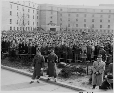Photograph of a crowd of spectators in the Pentagon Court, on the occasion of a ceremony honoring the retiring Army... - NARA - 199265