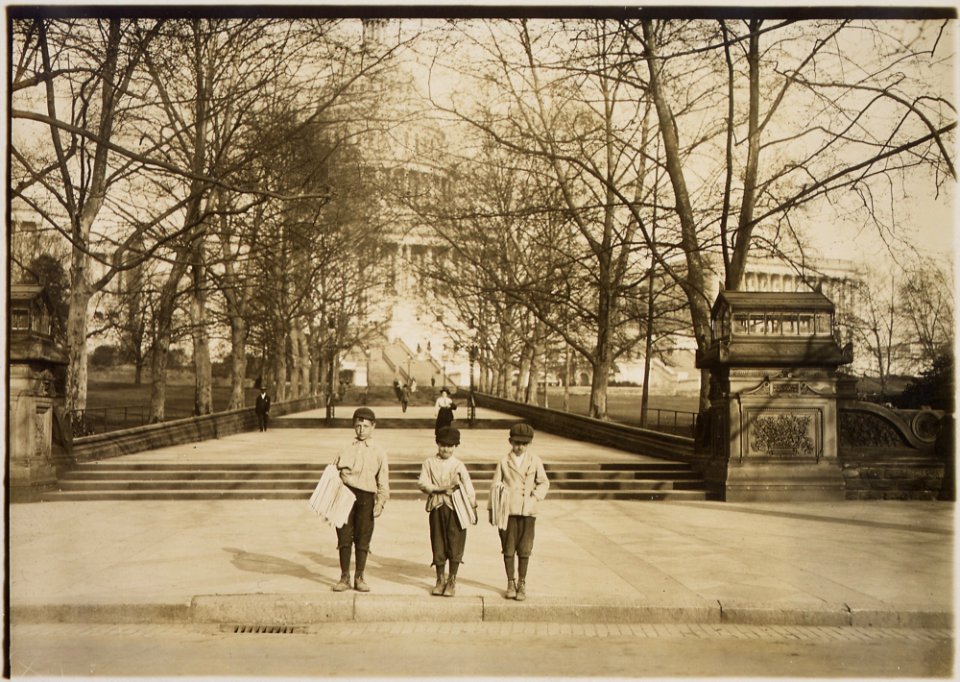 Photograph of a group of news-boys selling on the Capitol steps. Dan Mercurio, a 9 year old chronic truent, began... - NARA - 306620