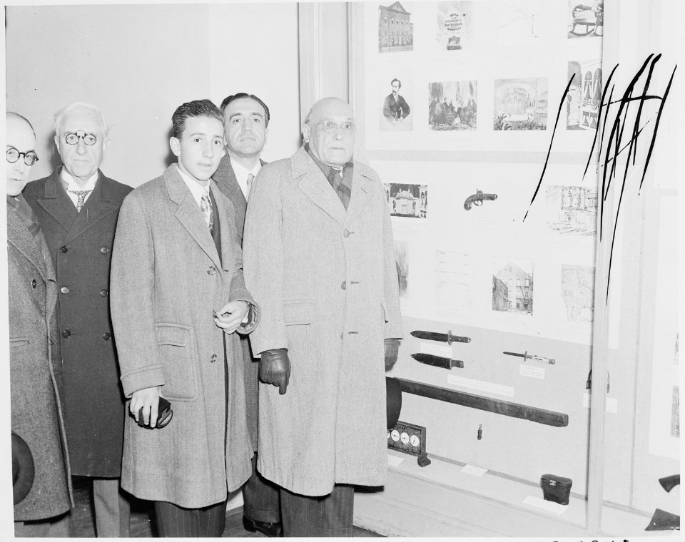 Photograph of a group of unidentified dignitaries in the Lincoln Museum at Ford's Theater, touring exhibits relating... - NARA - 199495