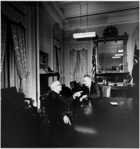 Photograph of former President Harry S. Truman conferring with President Lyndon B. Johnson, presumably at the White... - NARA - 200445