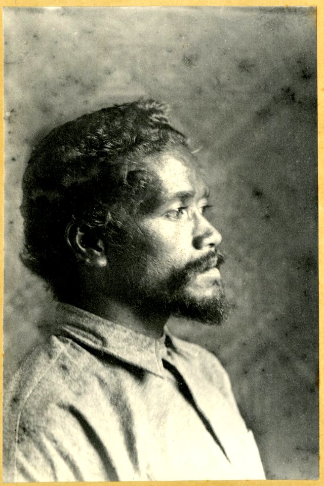 Photograph (black and white); portrait of a man in profile, in front of a plaited plant fibre wall, with a moustache and beard, wearing a shirt; Polynesia. Gelatin silver print. Oc,B48.23, British Museum