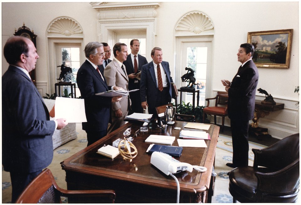 Photograph of President Reagan and his White House staff discussing the assassination of Egyptian President Anwar Sadat - NARA - 198521