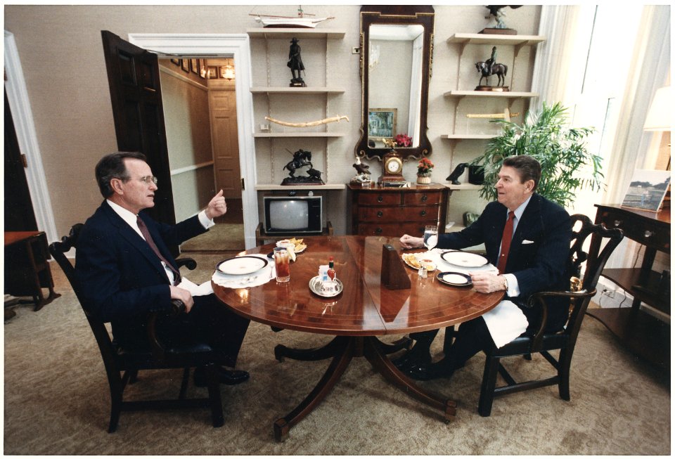 Photograph of President Reagan and Vice-President Bush eating lunch in the Oval Office Study - NARA - 198591
