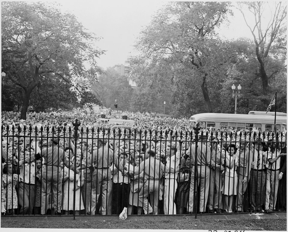 Photograph of a huge crowd outside the White House gates celebrating the Japanese surrender. - NARA - 199178