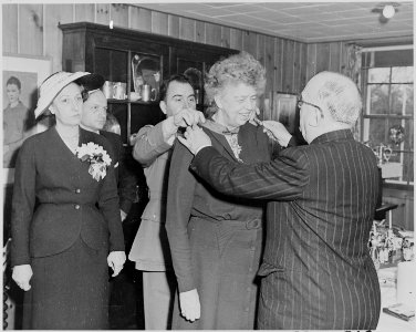 Photograph of French President Vincent Auriol presenting Eleanor Roosevelt with a medal, during his visit to the... - NARA - 200285