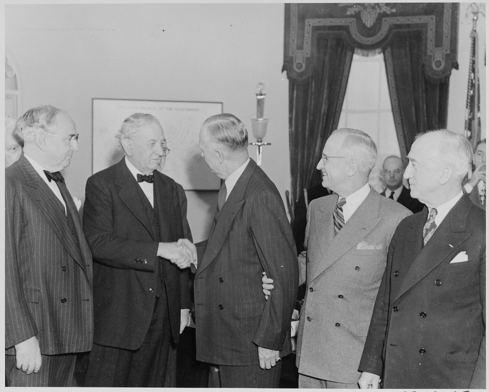 Photograph of George C. Marshall shaking hands with Senator Tom Connally of Texas, as Senator Arthur Vandenberg of... - NARA - 199518