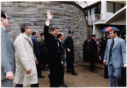 Photograph of President Reagan waving to crowds immediately before being shot in an assassination attempt, Washington... - NARA - 198513