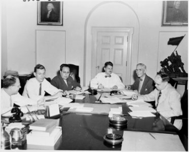Photograph of members of the Council of Economic Advisers and White House staff members working on the President's... - NARA - 200171