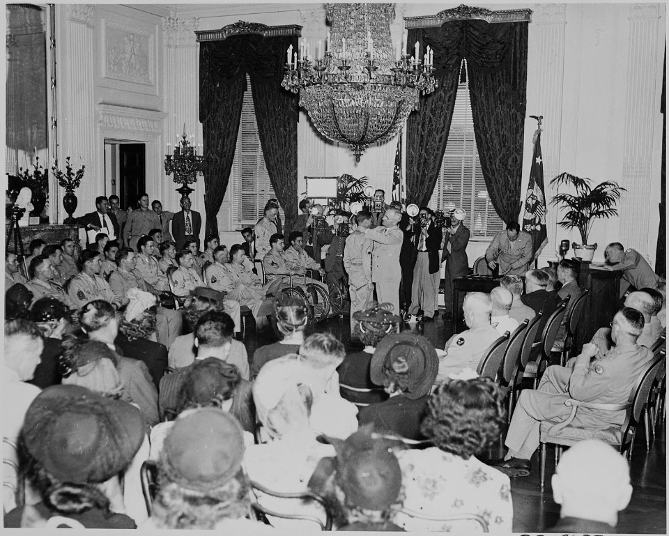 Photograph of President Truman decorating a soldier during a Medal of Honor presentation ceremony in the East Room of... - NARA - 199191