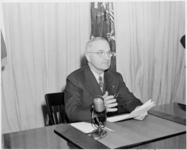 Photograph of President Truman delivering his radio speech to the nation on his program for reconversion to a... - NARA - 199291 photo