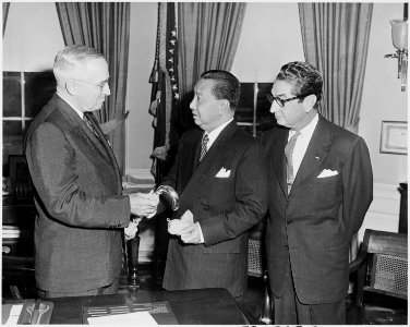 Photograph of President Truman in the Oval Office, evidently receiving a cane as a gift from the President of the... - NARA - 200320