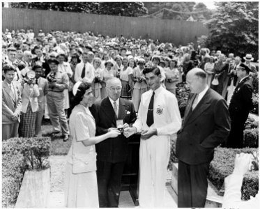 Photograph of President Truman in the White House Rose Garden, receiving a gold key from visiting delegates to the... - NARA - 200306