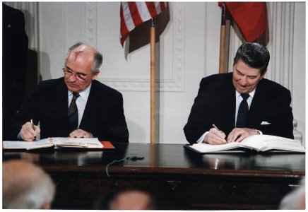 Photograph of President Reagan and General Secretary Gorbachev signing the INF Treaty in the East Room of the White... - NARA - 198588