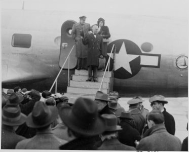 Photograph of President Truman waving from the steps leading to the door of his airplane at Washington's National... - NARA - 199286